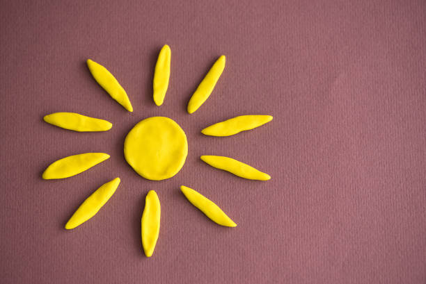istock Yellow sun on brown paper texture background. 1160776208