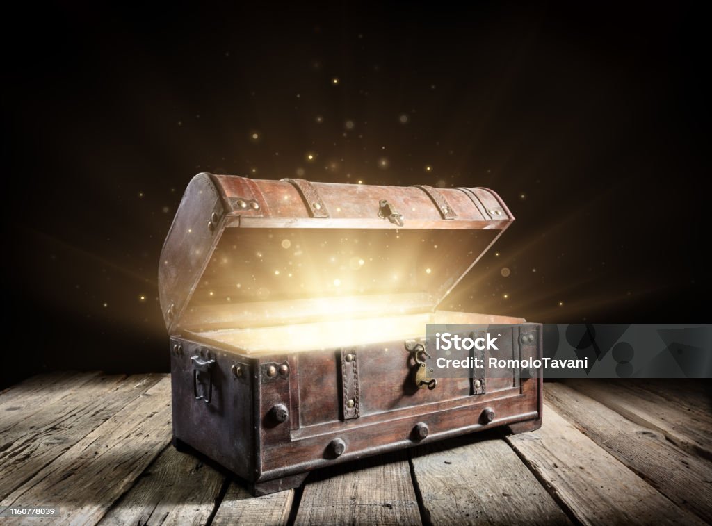 Treasure Chest - Open Ancient Trunk With Glowing Magic Lights In The Dark Treasure Chest Stock Photo