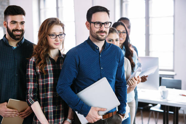 istock Portrait of successful business team posing in office 1160778321