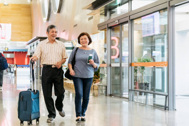 istock Active senior couple walking through airport 1160778450