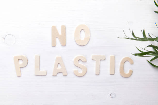 Text No plastic on white wooden backgound, ecological object concept, top view