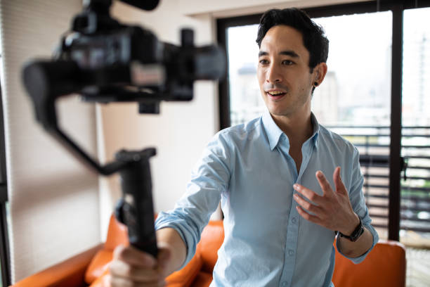 istock Hearing impaired man vlogging at home 1160779573