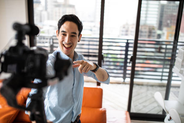 istock Mixed race man recording vlog in apartment 1160779617