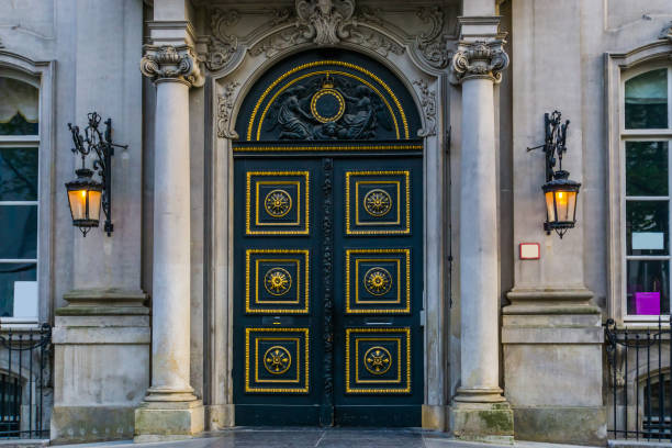 old historical doorway with columns and lighted lanterns, historic belgian city architecture