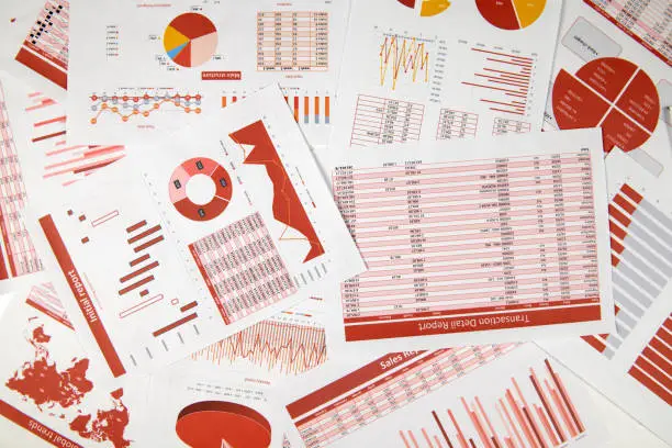 Photo of Flat top view of business workspace - reports with data, tables and analytic chart. Business financial accounting concept.