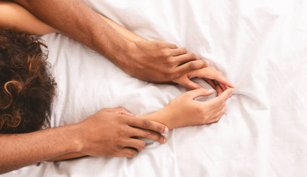 man and woman hands having sex on bed - men sensuality photography high angle view imagens e fotografias de stock