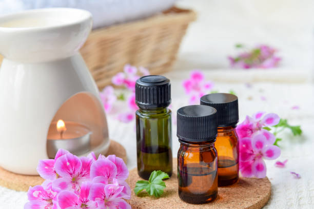 essential oils with rose geranium stock photo