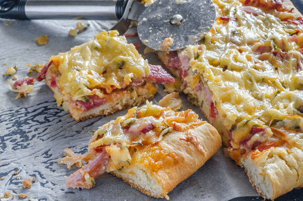 istock Cutting pizza on slices with special knife. 1160783235