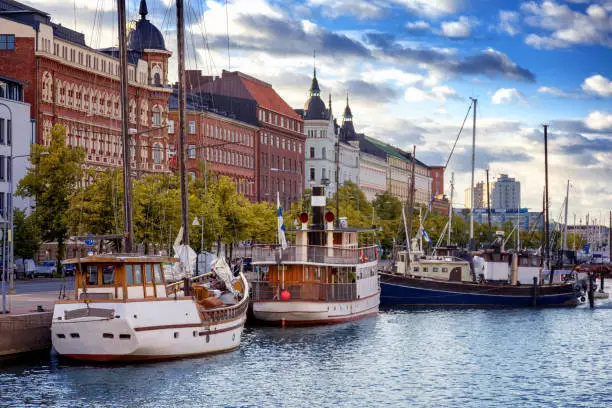 Beautiful cityscape, Helsinki, the capital of Finland, view of the embankment with boats and houses at sunset, travel to Northern Europe