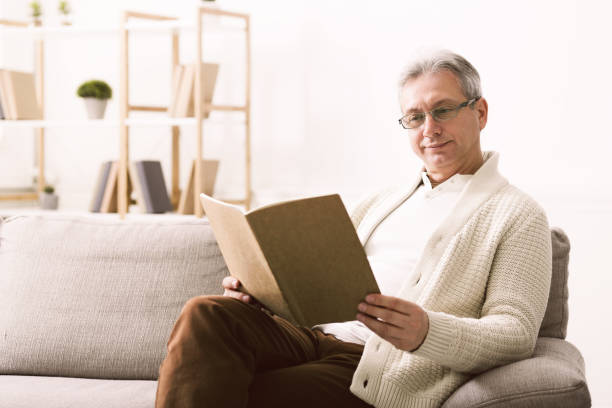istock Widower looking family photos and remembering moments 1160785261