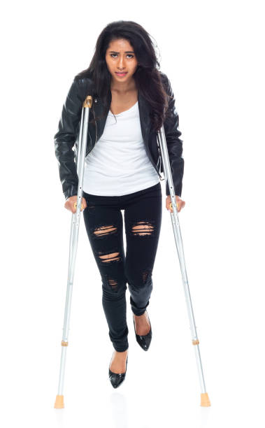 istock Bautiful woman wearing a leather jacket and using crutches 1160785449