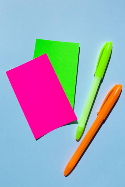 istock Neon colorful sticky note paper and pen on blue background. 1160787273