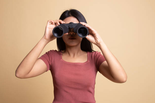 istock Young Asian woman with binoculars. 1160788947