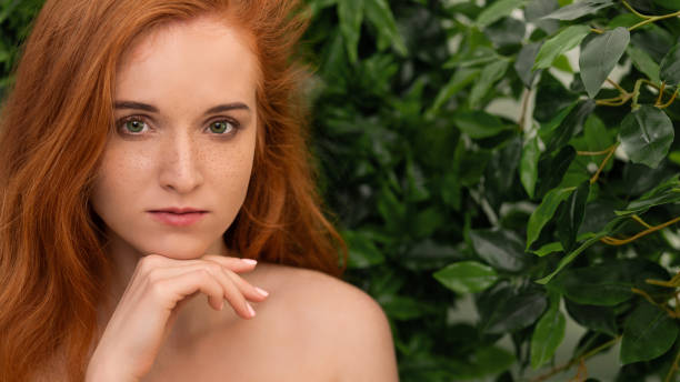 istock Young redhead girl looking at camera with pensive expression 1160790378