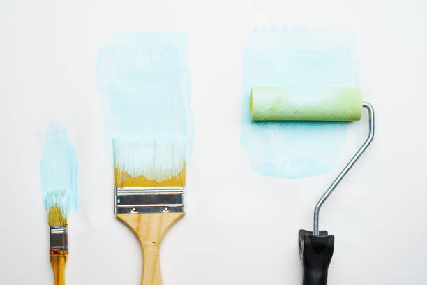 istock Photo of brushes and roller with blue paint 1160790549