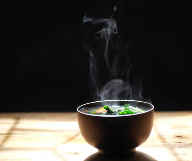 istock vegetables soup in bowl. black background. hot food. 1160790578