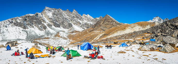 Sherpas and mountaineers in snowy camp high above the Khumbu valley deep in the Himalaya mountain wilderness of the Sagarmatha National Park, a UNESCO World Heritage Site, Nepal.