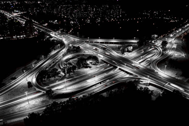 istock City interchange closeup at night , beautiful transport infrastructure background. Black and White. Aerial view 1160790636