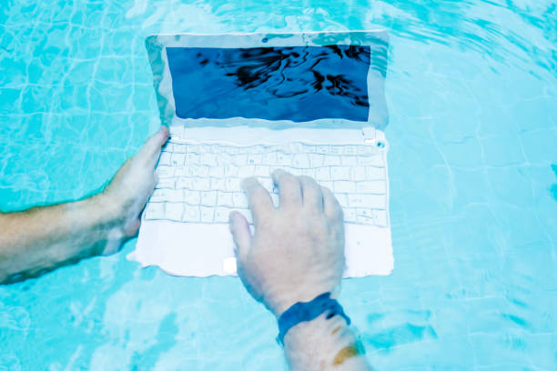 Male works on minicomputer under water. Minicomputer at the bottom of the pool. The concept of a lot of work at work. Blur abstract background. Male works on minicomputer under water. Minicomputer at the bottom of the pool. The concept of a lot of work at work. Blur abstract background deep pick stock pictures, royalty-free photos & images