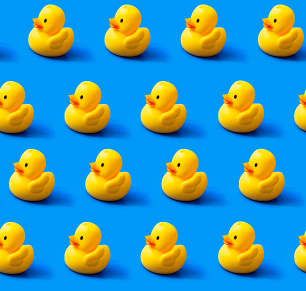 Seamless pattern rubber ducks on a blue background stock photo