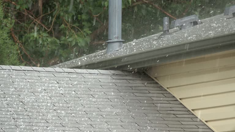 Hail falls on house roof shingles Denver Colorado heavy rain thunderstorm water