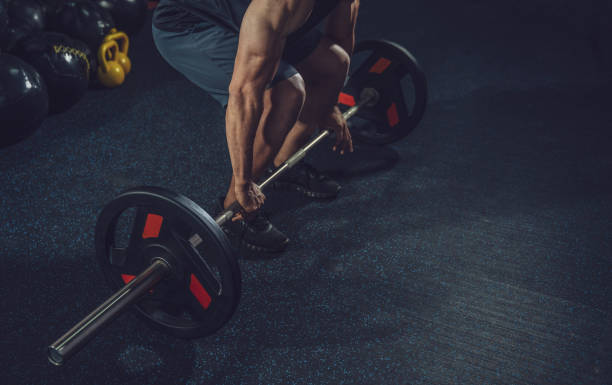 istock Handsome weightlifter preparing for training. Training with barbell, Athletic shirtless young sports man. Fitness model with barbell in gym 1160795381