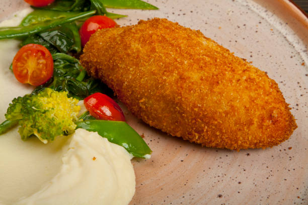 istock kiev cutlet with mash potato and vegetables 1160796683