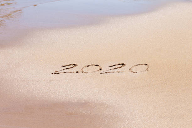 istock Happy new year 2020 text on the beach. Planning vacation. 1160797430