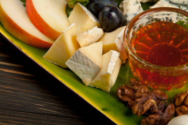 istock set of cheese, sliced apple and grape with honey 1160797537