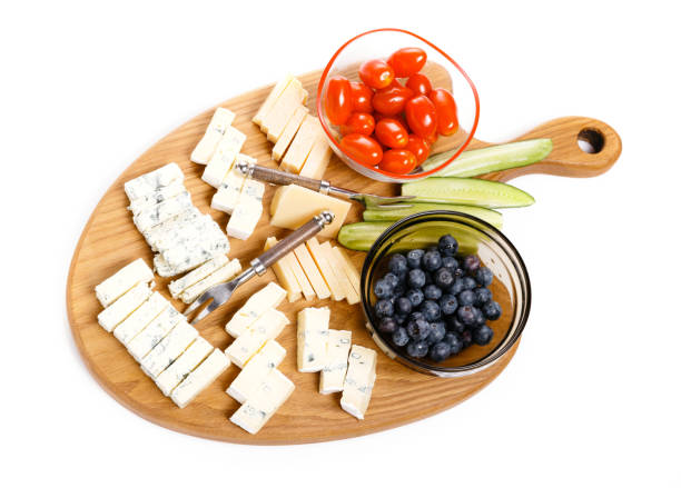 istock Wooden board with tasty cheese on white background 1160797538