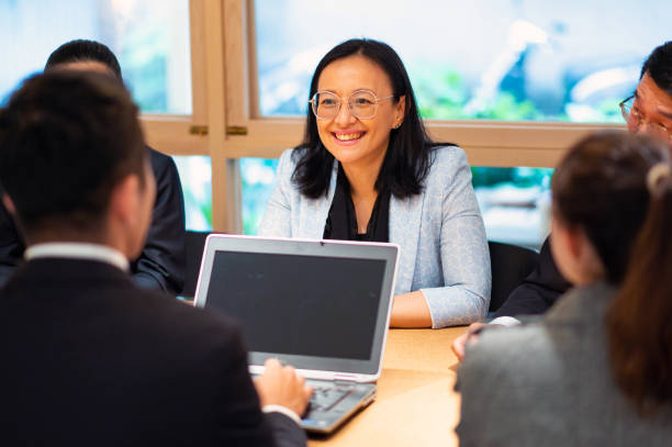 istock Businesswoman smiling during discussion in office 1160798915