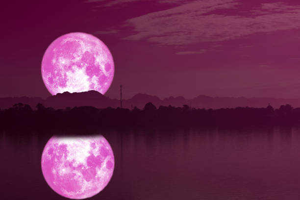 istock strawberry moon on night sky back silhouette mountain reflection on river 1160800769