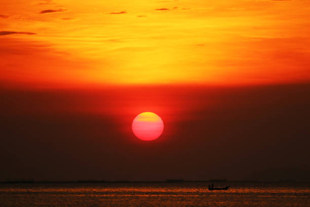 sunset on rainbow sky back evening cloud over twilight and fishing on sea