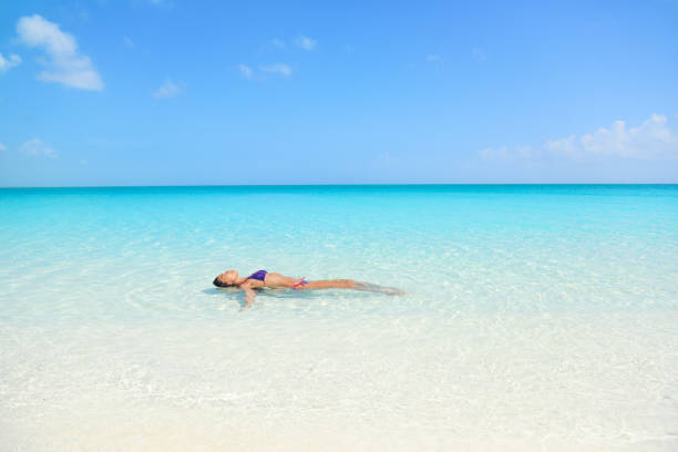 istock Beach woman swimming in ocean relaxing 1160800976