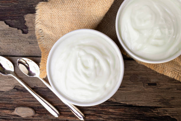 istock Yogurt  In white glass wood background from top view. 1160801165