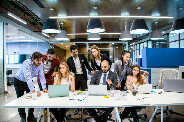 istock men and women in offices 1160801212