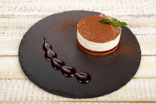 istock Cake tiramisu on black plate 1160802344