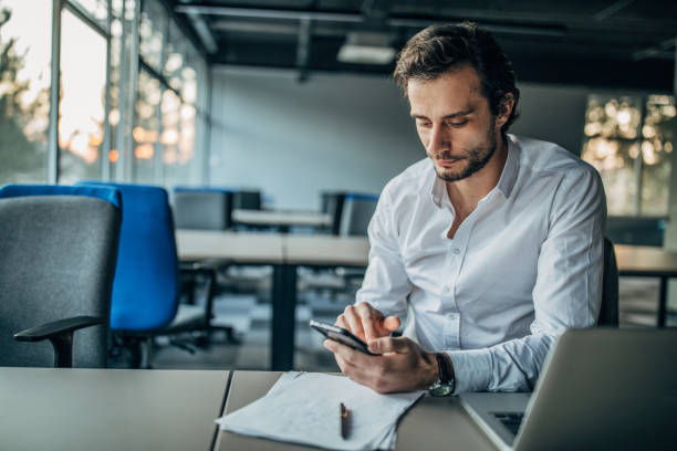 istock Businessman texting on phone 1160802528