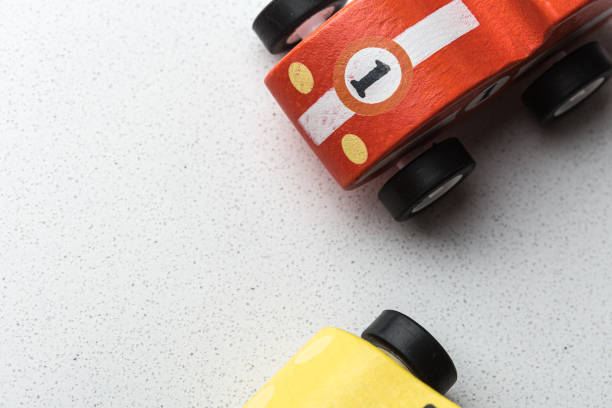 Tiny toy cars macro still on a textured white background