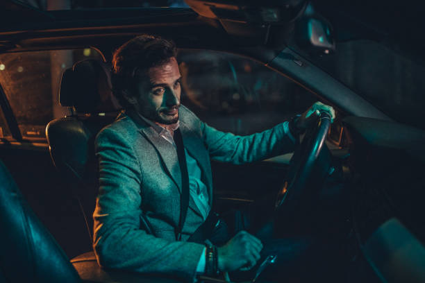 istock Businessman Driving A Car In Night 1160804153