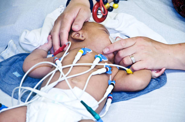 medical test being performed on a baby in hospital ward - nurse illness doctor heart disease imagens e fotografias de stock