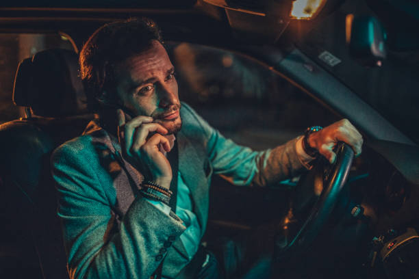 istock Businessman Driving A Car In Night 1160804408