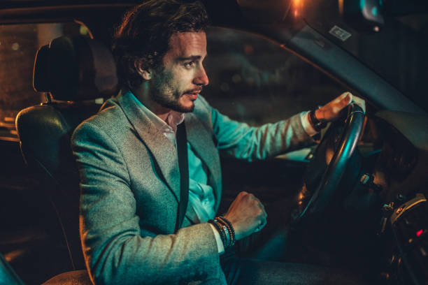 istock Businessman Driving A Car In Night 1160804494