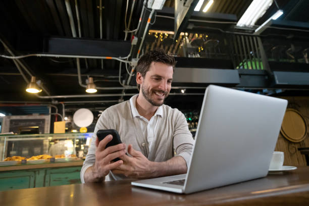 istock Casual business man at a cafe using technology 1160805967