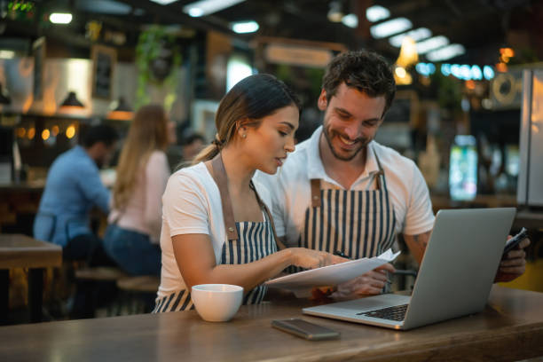 istock Waiters working at a restaurant doing the books 1160805998