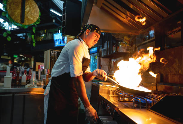 istock Chef cooking at a restaurant making food flambe 1160806015