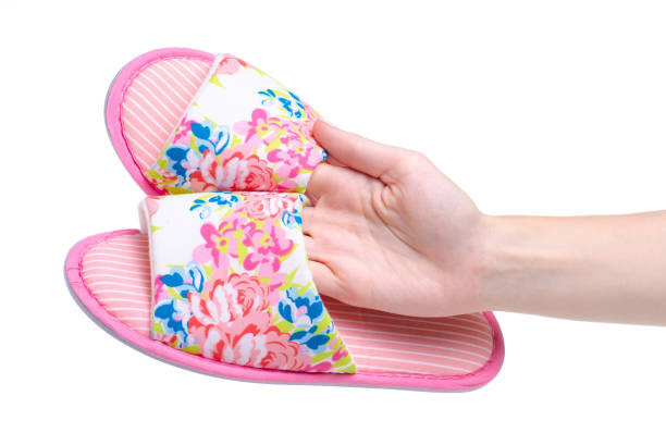 istock Female pink slippers in hand 1160807004