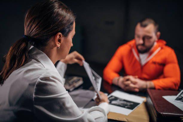 istock Prisoner and female detective 1160809673