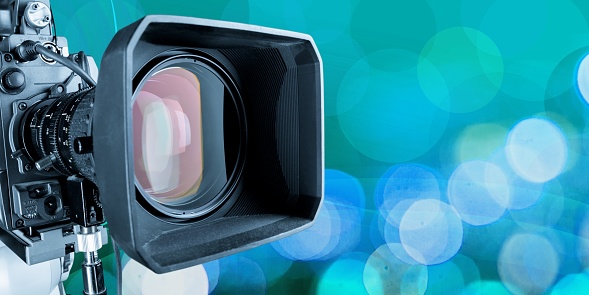 Close-up of a television camera lens on blurred background, bokeh