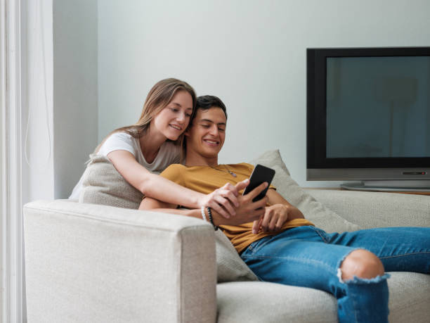 istock Young couple taking a selfie at home 1160811084